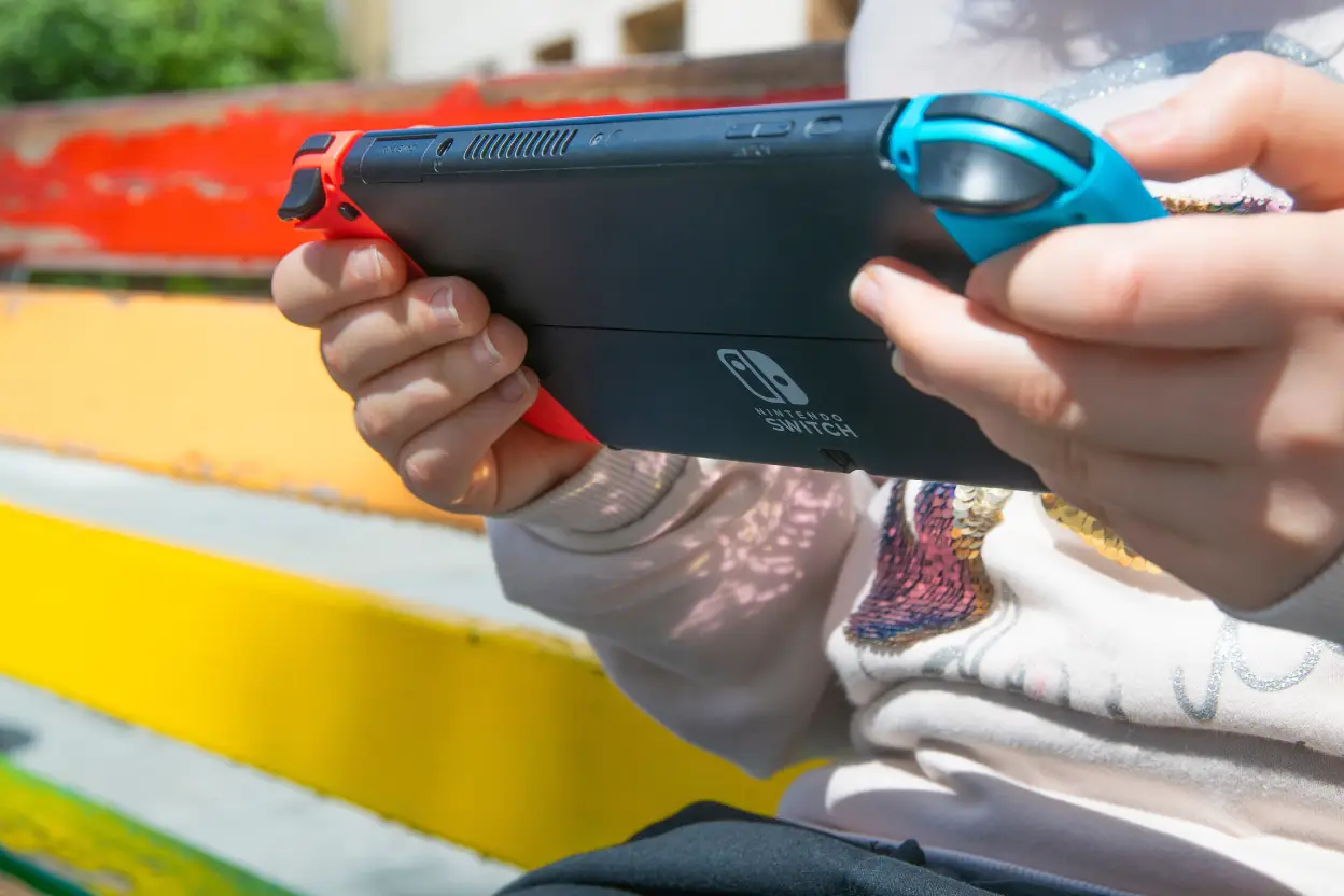 Picture of child playing a Nintendo Switcb