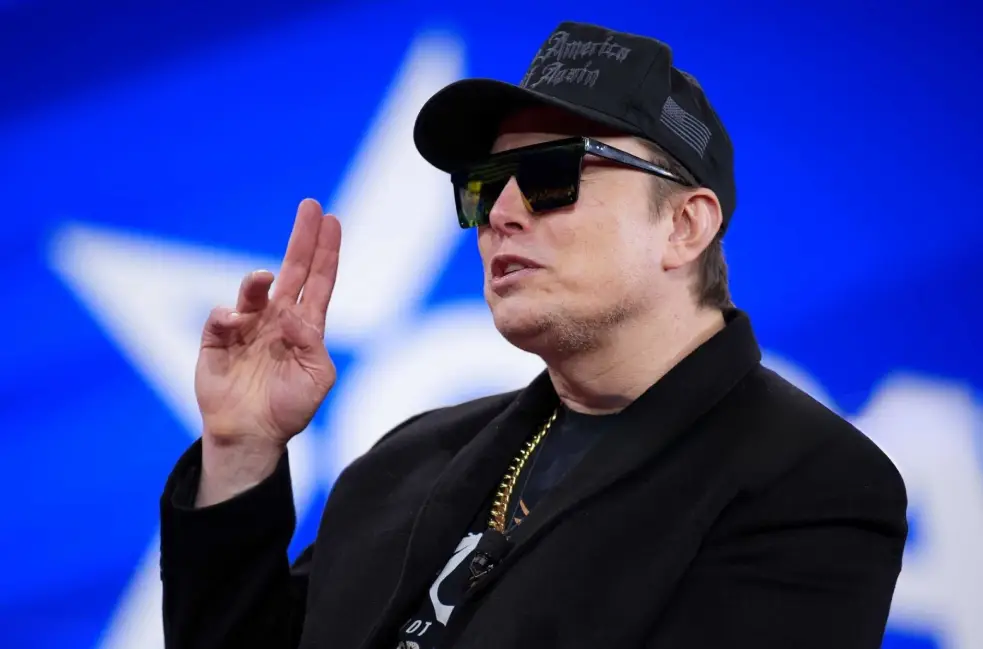 Elon Musk raising his fingers
