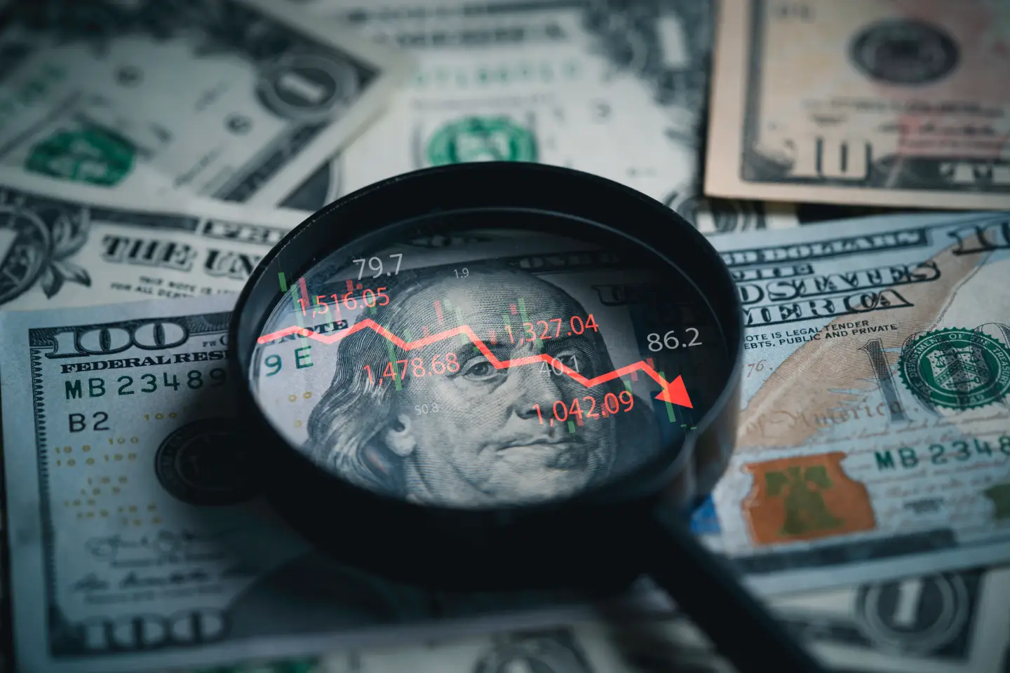 Stock image of cash and a magnifying glass