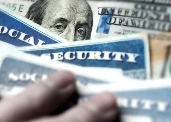 Stock image of social security cards and cash, symbolizing social security payments