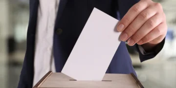 Stock photo of a man casting a ballot on Election Day