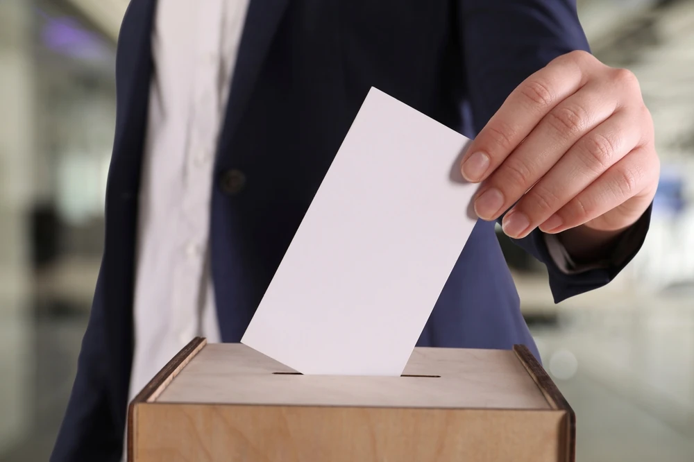 Stock photo of a man casting a ballot on Election Day